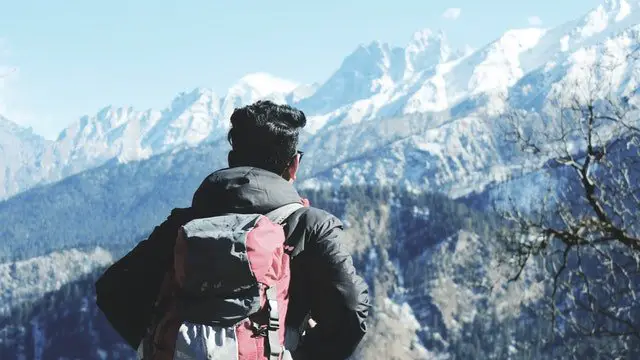 man hiker looking icy mountain