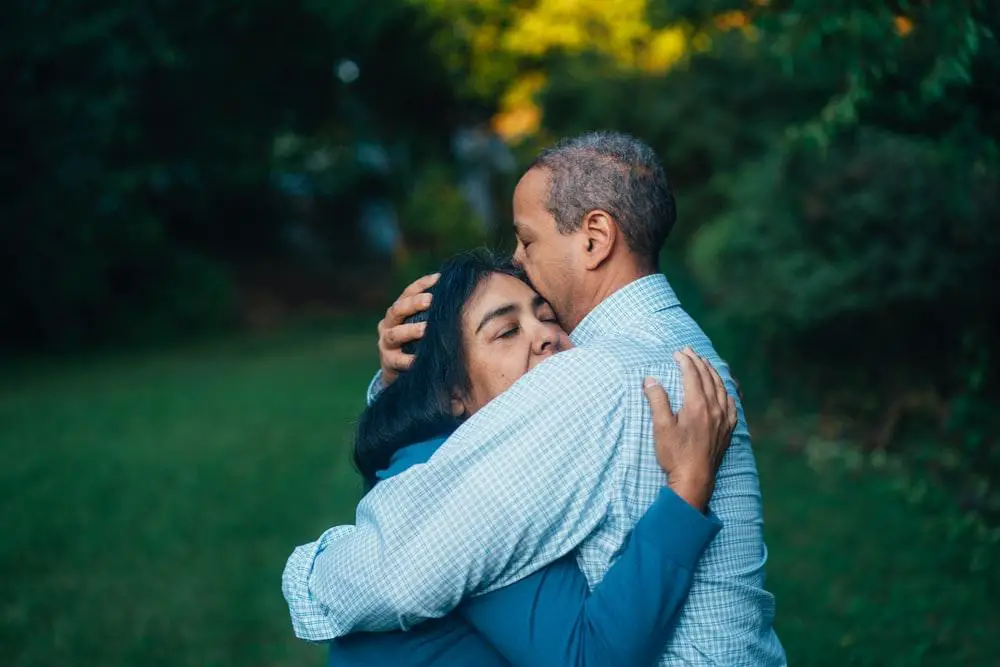 wife and husband embracing 